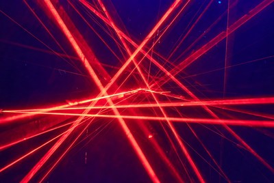 Red laser beams on dark background