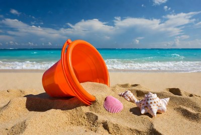 Orange beach pail with seashells
