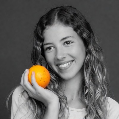 Girl holding orange fruit