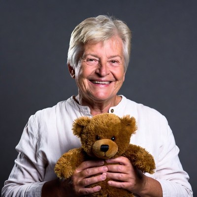 Elderly woman holding teddy bear