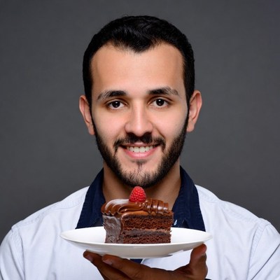 Man holding chocolate cake with raspberry