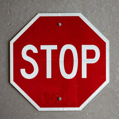 Red Stop Sign on Gray Pavement