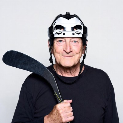 Elderly man holding hockey stick
