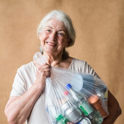 Elderly woman holding recycling bag