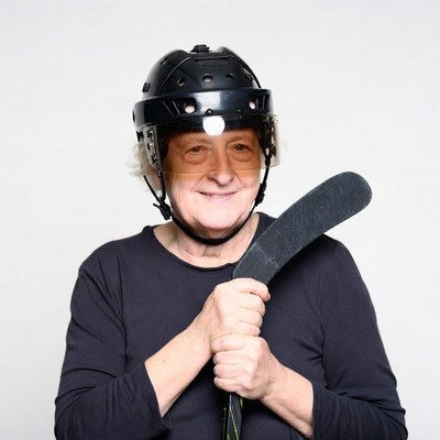 Elderly woman holding hockey stick