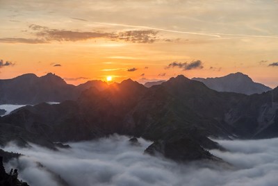 Sunrise over mountains with clouds