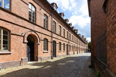 Long Red Brick Building Cobblestone Alley