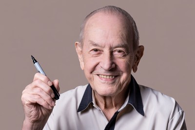 Elderly man holding marker