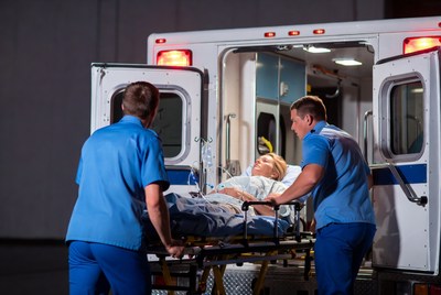 Paramedics Wheeling Patient into Ambulance