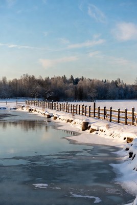 Wooden Fence Along Snowy Lakeside