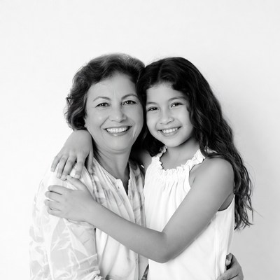 Grandmother hugging smiling girl