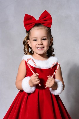 Girl in red velvet candy cane dress
