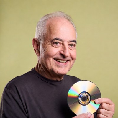 Elderly man holding CD