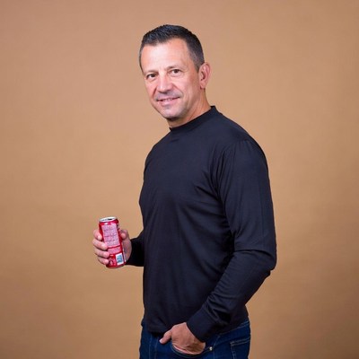 Man holding red soda can