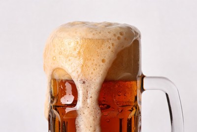 Beer mug with overflowing foam