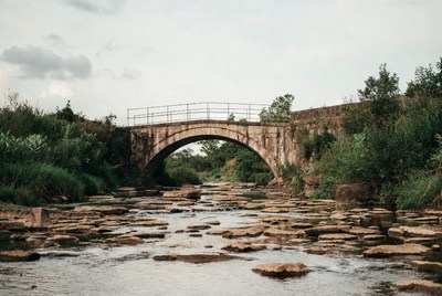 Stone Arch Bridge over Rocky Stream