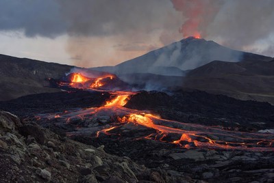 Volcano erupting with glowing lava flows