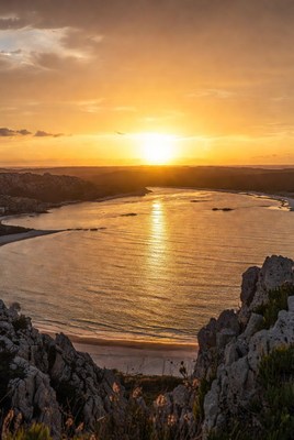 Sunset over coastal bay and cliffs