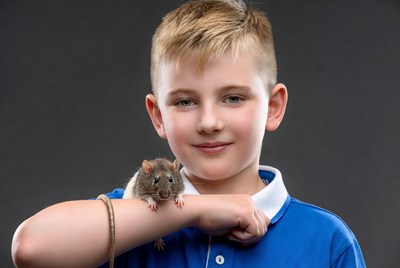 Boy holding rat on arm