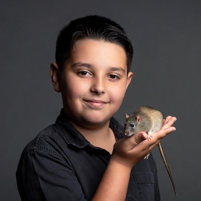 Boy holding pet rat