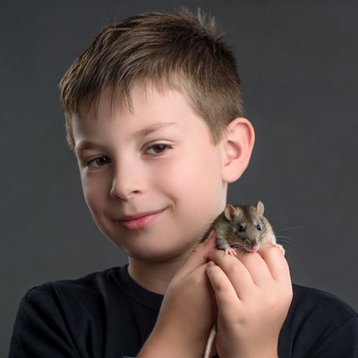 Boy holding cute rat
