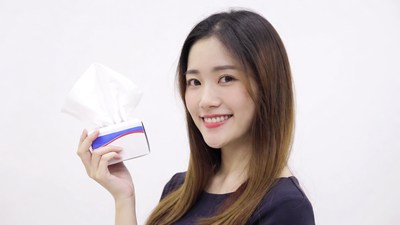 Asian woman holding tissue box