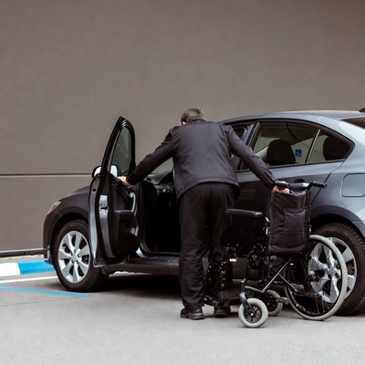 Man helping wheelchair from car