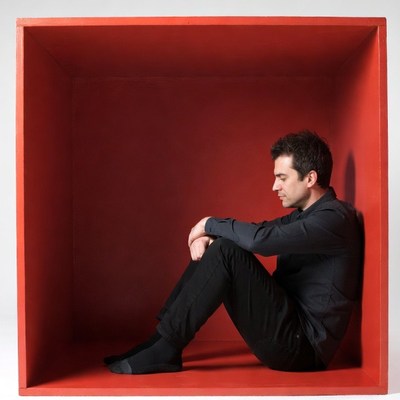 Man sitting in red box