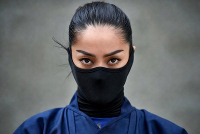 Asian woman in ninja mask and outfit