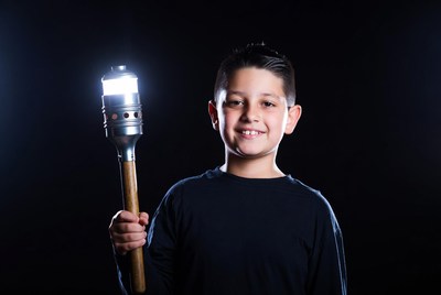 Boy holding lit torch