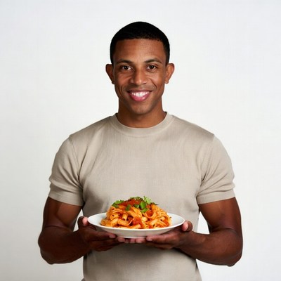 African-American man holding spaghetti plate