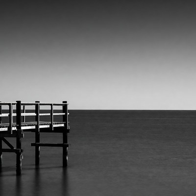 Wooden pier extending over calm sea