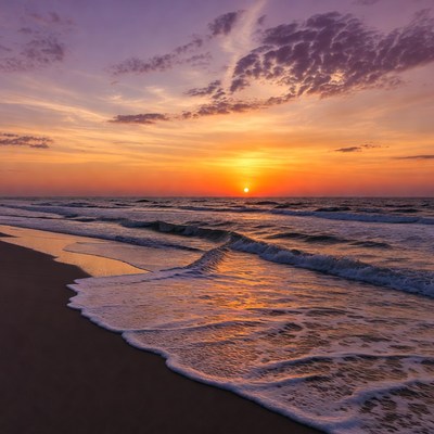 Sunset over ocean waves beach