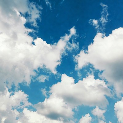 Fluffy White Clouds in Blue Sky