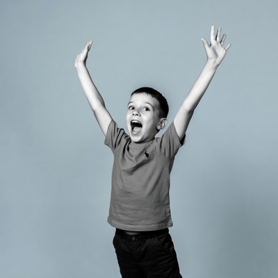 Boy raising arms excitedly