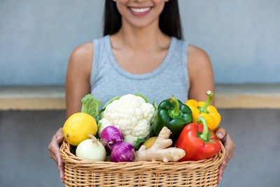 Woman holding fresh vegetables basket