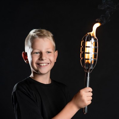 Boy holding flaming torch