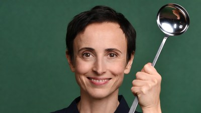 Woman holding ladle smiling