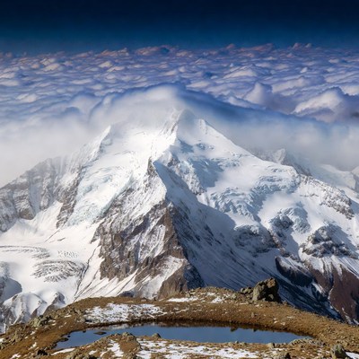 Snowy Mountain Peak Above Clouds