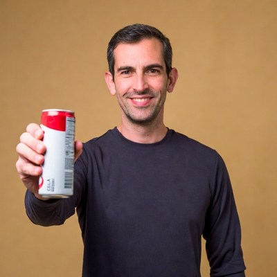 Man holding Olipop soda can