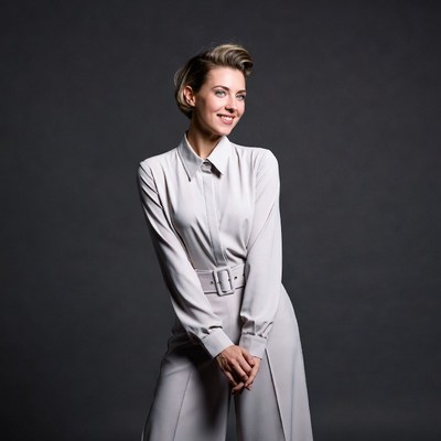 Smiling woman in white jumpsuit