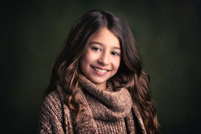 Smiling girl with curly hair and scarf