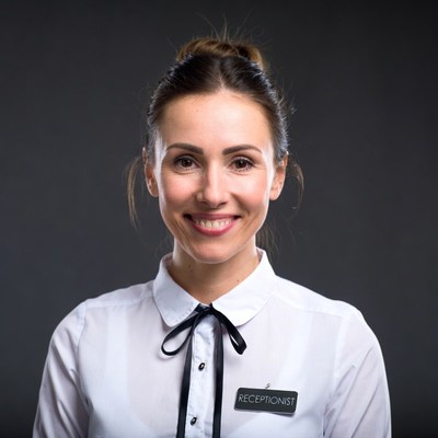 Smiling receptionist woman in white shirt