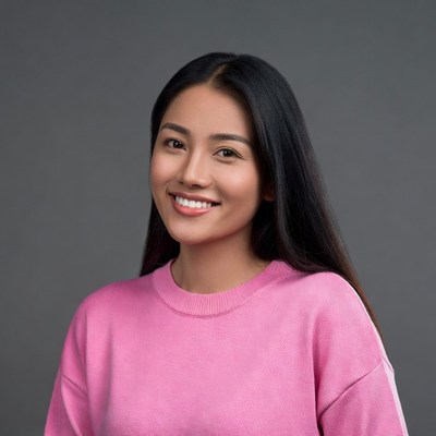 Asian woman smiling in pink sweater