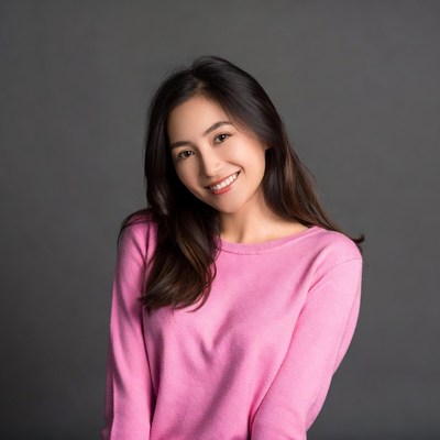 Asian woman smiling in pink sweater