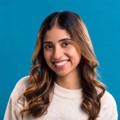 Smiling Latino woman on blue background