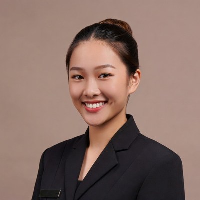 Asian woman in black suit smiling