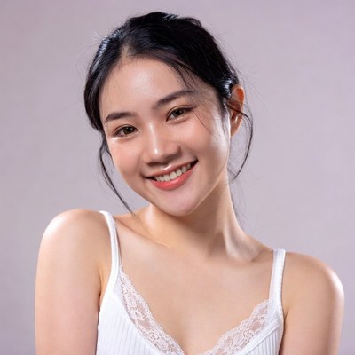 Asian woman smiling in white camisole