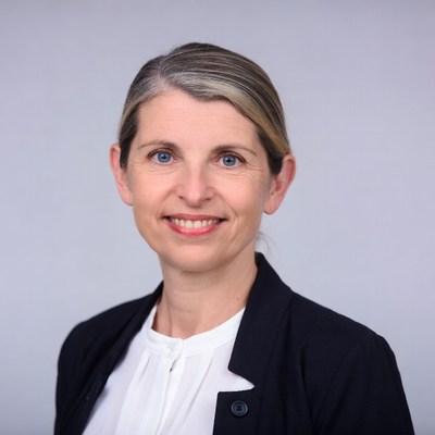 Smiling woman in black blazer