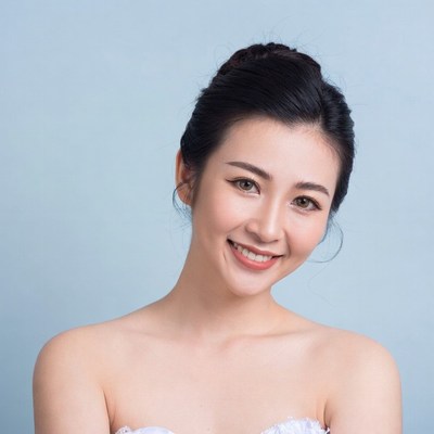 Smiling Asian woman in white dress